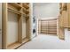 Spacious walk-in closet with natural wood shelving and a convenient washer/dryer at 42 Carolina Cherry Dr, Las Vegas, NV 89141