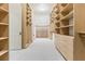 Large walk-in closet offers ample storage with wooden shelving and built-in drawers at 42 Carolina Cherry Dr, Las Vegas, NV 89141