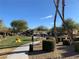 Beautiful community park with lush green grass, mature trees, playground, and walking paths at 4675 Color Up Ct # 101, Las Vegas, NV 89122