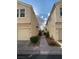 Exterior view of townhouse with sidewalk leading to rear units at 4675 Color Up Ct # 101, Las Vegas, NV 89122