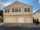 Three-car garage townhouse with neutral color scheme and well-maintained landscaping at 4675 Color Up Ct # 101, Las Vegas, NV 89122