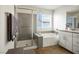 Bathroom featuring a double vanity, shower, and bathtub with modern fixtures at 4698 Lucky Jade Ave, Las Vegas, NV 89141