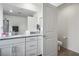 Modern bathroom with double vanity, spacious mirror, and separate toilet area at 4698 Lucky Jade Ave, Las Vegas, NV 89141