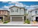 Inviting two-story home with a two-car garage, tidy landscaping, and charming architectural details at 4698 Lucky Jade Ave, Las Vegas, NV 89141