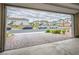 Garage with a view of the neighborhood's street with parked cars and landscaped houses at 4698 Lucky Jade Ave, Las Vegas, NV 89141