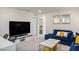 Cozy living room with comfortable blue seating, TV, and stylish decor at 4698 Lucky Jade Ave, Las Vegas, NV 89141