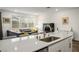 Open-concept area with a large island, living room with large sectional and lots of natural light at 4698 Lucky Jade Ave, Las Vegas, NV 89141