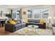 Open-concept living area with large sectional sofa, rug, and access to the backyard at 4698 Lucky Jade Ave, Las Vegas, NV 89141