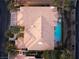 An aerial view of a luxury home highlighting the tile roof, pool with rock features and mature landscaping at 5020 Spanish Heights Dr, Las Vegas, NV 89148