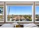 Stunning view from a bedroom window overlooking a neighborhood with palm trees and city buildings at 5020 Spanish Heights Dr, Las Vegas, NV 89148