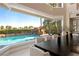 Elegant dining room featuring a large window overlooking a beautiful pool and landscaped backyard at 5020 Spanish Heights Dr, Las Vegas, NV 89148