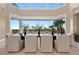 Well-lit dining room with a large table perfect for entertaining, offering serene views of the outdoor landscape at 5020 Spanish Heights Dr, Las Vegas, NV 89148