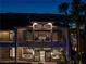 A two-story home featuring several balconies, large windows, a pool, and mature landscaping at 5020 Spanish Heights Dr, Las Vegas, NV 89148