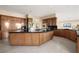 Spacious kitchen featuring wood cabinetry, a large island, and modern appliances at 5020 Spanish Heights Dr, Las Vegas, NV 89148