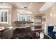 Bright living room features hardwood floors, a bar, ample windows, and comfortable seating at 5020 Spanish Heights Dr, Las Vegas, NV 89148