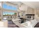 Spacious living room with large windows, fireplace, and stylish furnishings at 5020 Spanish Heights Dr, Las Vegas, NV 89148