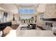Spacious living room with fireplace, luxurious sofas, and open floor plan at 5020 Spanish Heights Dr, Las Vegas, NV 89148