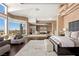 Luxurious main bedroom boasts natural light, neutral tones, and a sitting area with views at 5020 Spanish Heights Dr, Las Vegas, NV 89148