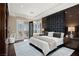 Luxurious bedroom featuring a dark headboard and access to an outdoor balcony with scenic views at 5020 Spanish Heights Dr, Las Vegas, NV 89148