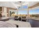 Bright, open main bedroom with fireplace and city views through expansive windows at 5020 Spanish Heights Dr, Las Vegas, NV 89148