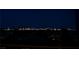 Night view of the Las Vegas skyline with city lights illuminating the horizon, creating a picturesque scene at 5020 Spanish Heights Dr, Las Vegas, NV 89148