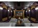 This private home theatre features tiered seating, a large projection screen, and custom lighting at 5020 Spanish Heights Dr, Las Vegas, NV 89148