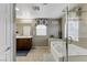 Bright bathroom with a soaking tub, separate shower, and dual vanity sinks at 5144 Poem Ct, North Las Vegas, NV 89081