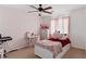 Bedroom featuring pink accents, a ceiling fan, a desk, and a pull out bed at 5144 Poem Ct, North Las Vegas, NV 89081
