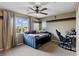 Comfortable bedroom featuring a ceiling fan and view from a large window at 5144 Poem Ct, North Las Vegas, NV 89081
