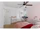 Bedroom featuring pink accents, a ceiling fan, a desk, and a pull out bed at 5144 Poem Ct, North Las Vegas, NV 89081