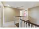 Bright hallway with white railing, neutral walls, and multiple doorways leading to other rooms upstairs at 5144 Poem Ct, North Las Vegas, NV 89081
