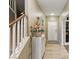 Hallway with stairs and tile floor with a decorative table and easter decorations at 5144 Poem Ct, North Las Vegas, NV 89081