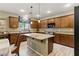 Modern kitchen with granite countertops, island with bar seating, stainless steel appliances, and ample cabinetry at 5144 Poem Ct, North Las Vegas, NV 89081