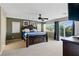 Spacious bedroom featuring a large bed, balcony access, and modern decor at 5144 Poem Ct, North Las Vegas, NV 89081