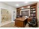 Inviting home office features a built-in desk, shelving, and an abundance of natural light at 5144 Poem Ct, North Las Vegas, NV 89081