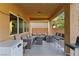 Spacious covered patio furnished with a comfortable seating area, bar stools, and a refrigerator, ideal for outdoor gatherings at 5144 Poem Ct, North Las Vegas, NV 89081