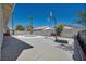 Backyard featuring a refreshing pool, basketball hoop, and palm trees at 520 Stonehurst Dr, North Las Vegas, NV 89031