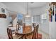A bright dining room with a sliding door, table, and hanging light fixture at 520 Stonehurst Dr, North Las Vegas, NV 89031