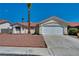 Inviting single-story home with a well-manicured yard and a two-car garage at 520 Stonehurst Dr, North Las Vegas, NV 89031