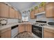 A kitchen featuring white appliances, light wood cabinets, and neutral countertops at 520 Stonehurst Dr, North Las Vegas, NV 89031