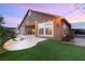 Serene backyard with pool, artificial turf, and stucco home with carport at 5940 Vizzi Ct, Las Vegas, NV 89131