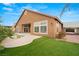 Beautiful backyard featuring artificial turf, pool, and a stucco home with plenty of windows at 5940 Vizzi Ct, Las Vegas, NV 89131