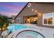 Beautiful backyard featuring a pool, spa, patio, and lush landscaping, perfect for outdoor entertaining at 5940 Vizzi Ct, Las Vegas, NV 89131
