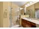 Updated bathroom featuring glass-enclosed shower and vanity with stone countertop at 5940 Vizzi Ct, Las Vegas, NV 89131