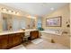 Spa-like bathroom featuring double vanities, a soaking tub, and a separate shower at 5940 Vizzi Ct, Las Vegas, NV 89131