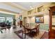 Traditional dining room featuring wood floors, decor shelves, and natural light for elegant meals at 5940 Vizzi Ct, Las Vegas, NV 89131
