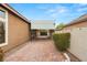 Brick driveway under carport leading to black security gate with stone and stucco walls at 5940 Vizzi Ct, Las Vegas, NV 89131