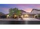 Inviting single-Gathering home featuring desert landscaping, warm lighting, and a convenient two-car garage at 5940 Vizzi Ct, Las Vegas, NV 89131