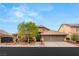 Charming two-story home with a well-manicured front yard and three-car garage at 5940 Vizzi Ct, Las Vegas, NV 89131