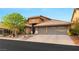 Charming single-story home featuring a tile roof, desert landscaping, and spacious two-car garage at 5940 Vizzi Ct, Las Vegas, NV 89131